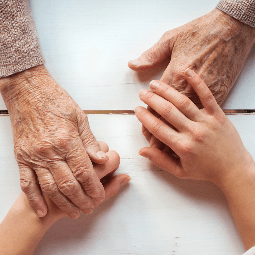 Seniors hands holding child hands