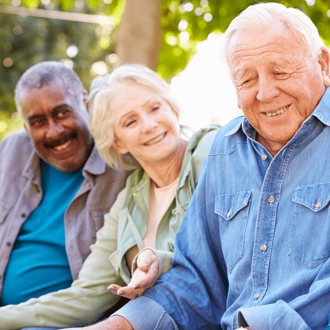 Three seniors sitting together and laughing