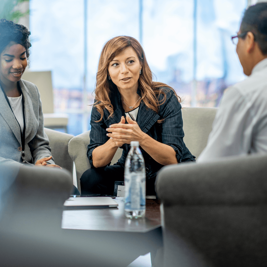 A woman meets with a male and female colleague