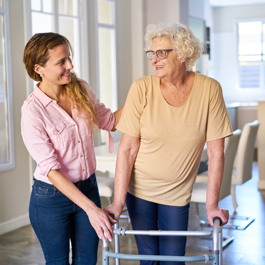 Woman helping a senior woman with walker